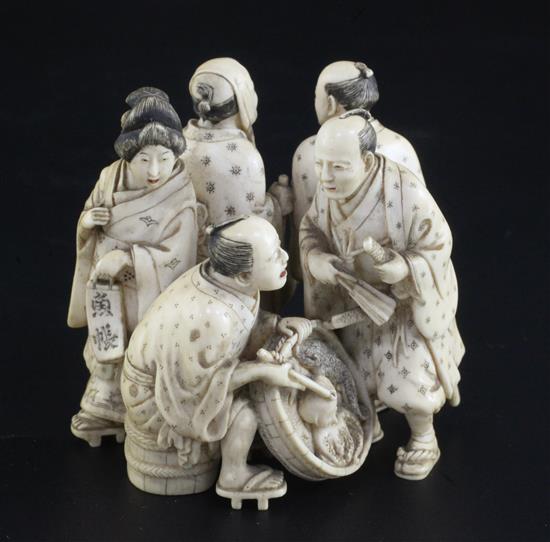 A good Japanese ivory okimono of five street pedlars or performers, signed Ikkosai, Meiji period, height 6.2cm